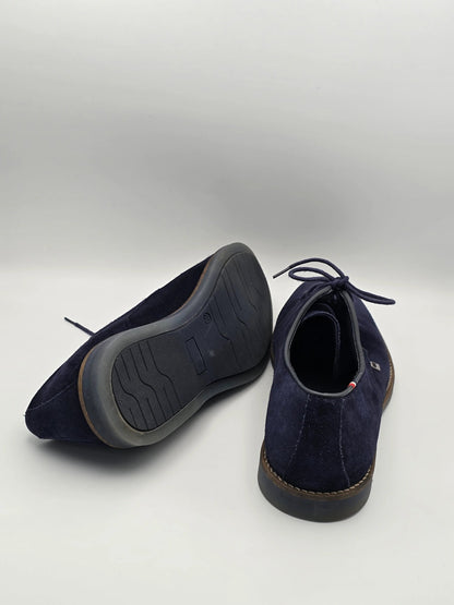 Dunkelblaue Wildleder-Schuhe mit Schnürung und Gummisohle auf weißem Hintergrund